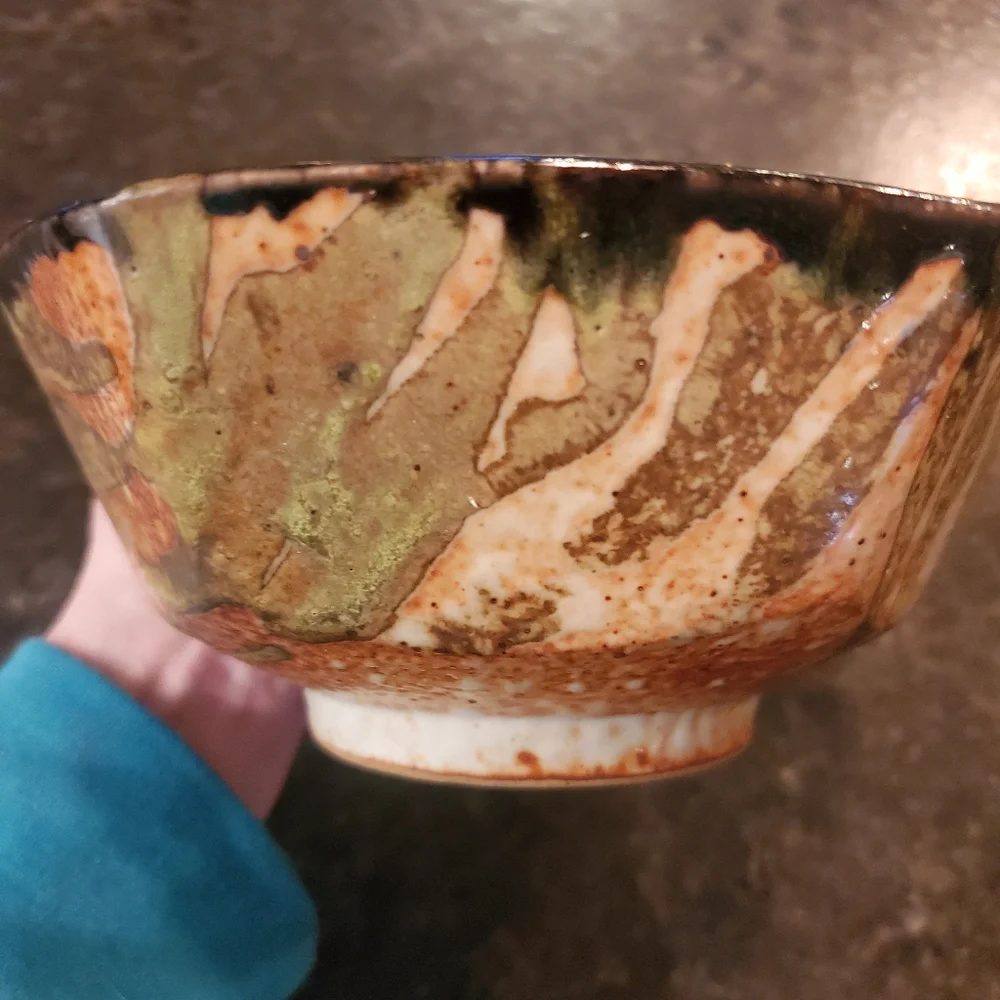 Handmade tiger stripe ceramic bowl signed by artist orange, cream & black